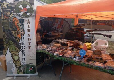 Stand de Woodpeckers con productos de paintball y airsoft en feria especializada.